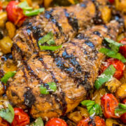 Grilled chicken breast with herbs and roasted vegetables.