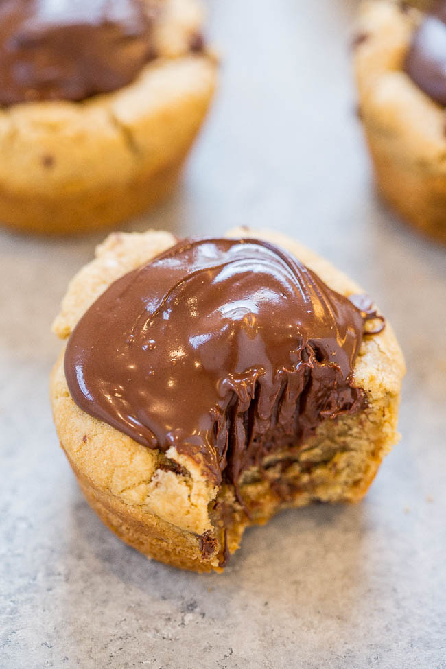 One Chocolate Lava Chocolate Chip Cookie Cups with a bite taken out of it