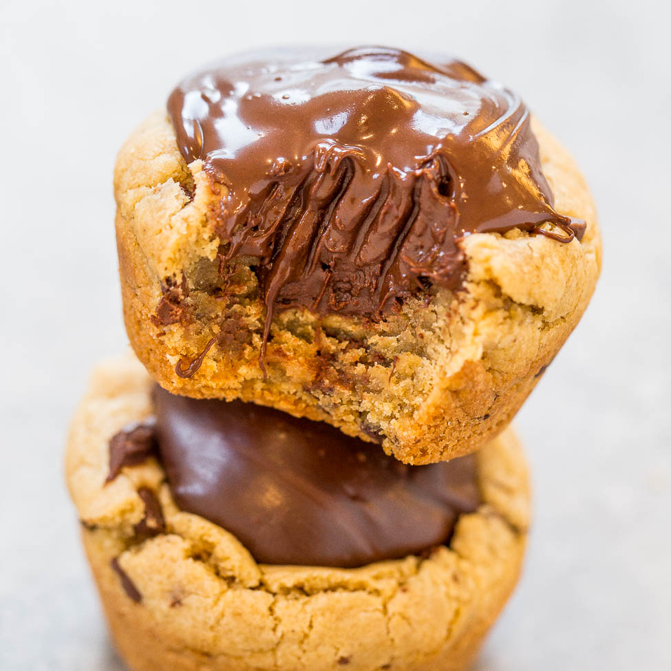 A stack of two chocolate-filled cookies with melted chocolate on top.