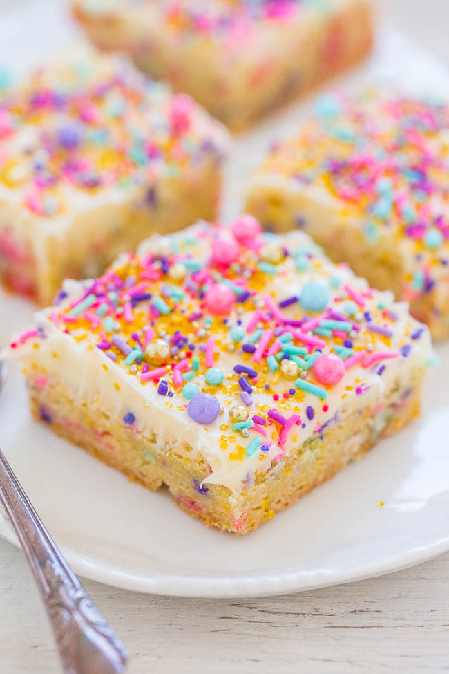 Frosted Springtime Sugar Cookie Bars on white plate with sprinkles