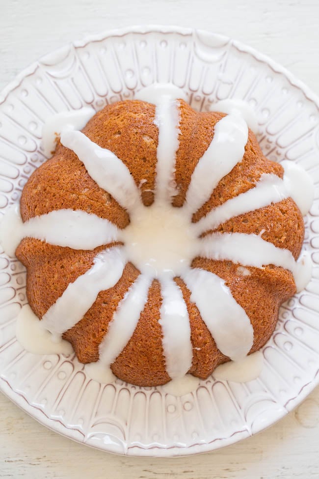 overhead view of a glazed cinnamon roll bundt cake on a white plate