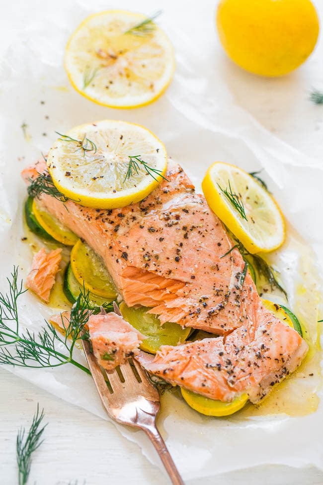Lemon Dill Salmon with Vegetables in Parchment with a fork and dill sprigs