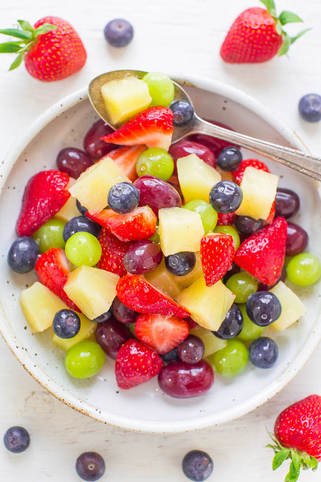 Pina Colada Fruit Salad - This EASY fruit salad is ready in 5 minutes tastes like a TROPICAL vacation!! The fruit is tossed in pineapple juice and pina colada mix! Guaranteed party and potluck WINNER!!