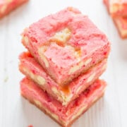 A stack of pink strawberry bars with a visible layer of fruit filling.