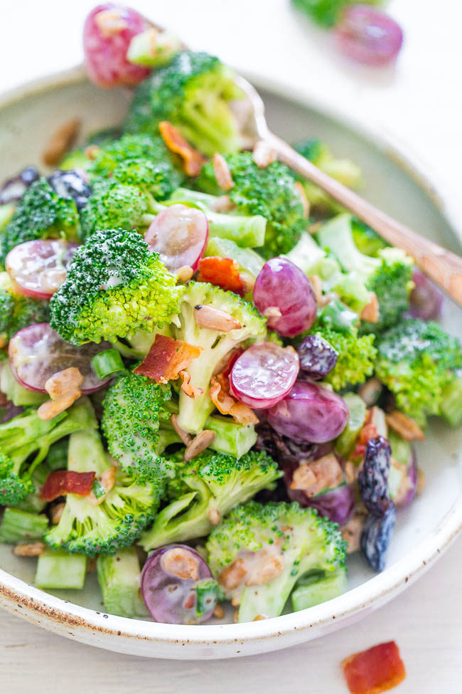 A white bowl and forkful of The Best Broccoli Salad