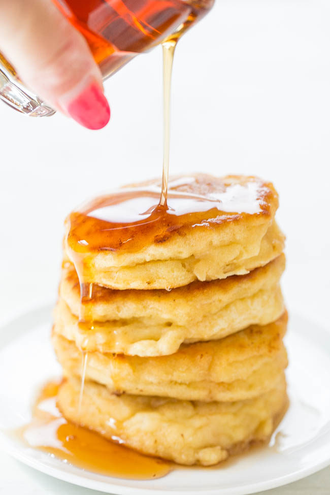 Syrup being poured on Thick and Fluffy Mini Buttermilk Pancakes