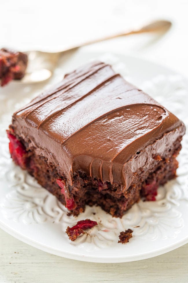 Slice of Triple Chocolate Cherry Cake  on a white plate