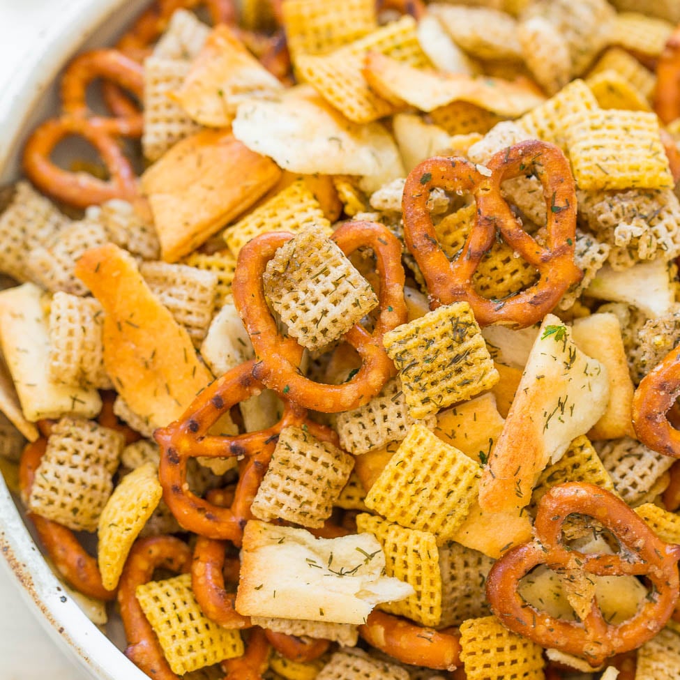 A bowl of mixed savory snacks, including pretzels and seasoned crackers.