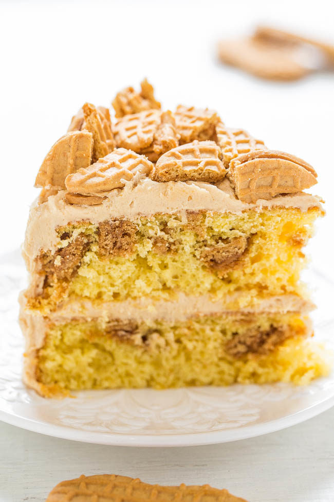 Nutter Butter Peanut Butter Layer Cake - Soft yellow cake with Nutter Butters baked in AND sprinkled on top!! The peanut butter FROSTING is rich, creamy, and decadent! Peanut butter fans will LOVE this cake!!