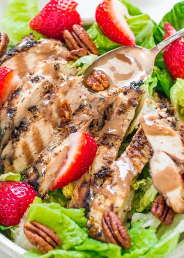 Grilled chicken salad with strawberries and pecans.