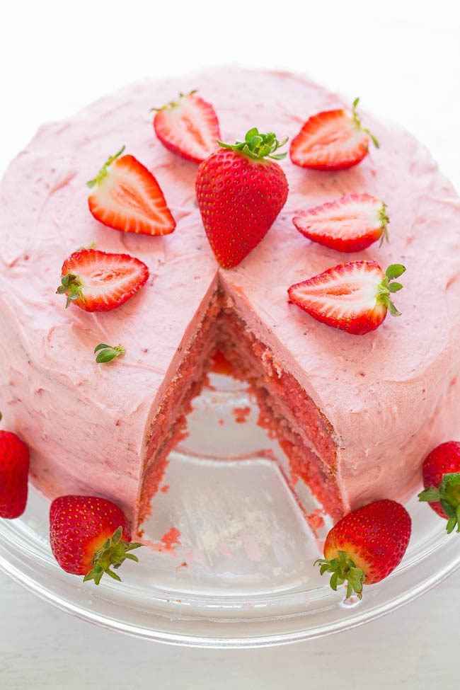 Strawberry Layer Cake with Strawberry Frosting - Soft, tender cake loaded with FRESH strawberries and a sweet strawberry frosting!! An EASY layer cake that's perfect for parties! Strawberry fans will LOVE IT!!