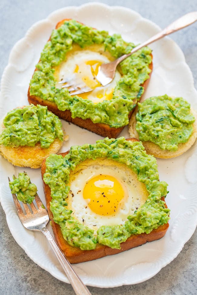 Egg-In-A-Hole Avocado Toast - Slathering warm egg-in-a-hole toast with a creamy chive and lime-scented avocado spread is beyond DELICIOUS!! It's an EASY recipe that's ready in 15 minutes and is perfect ANYTIME!!