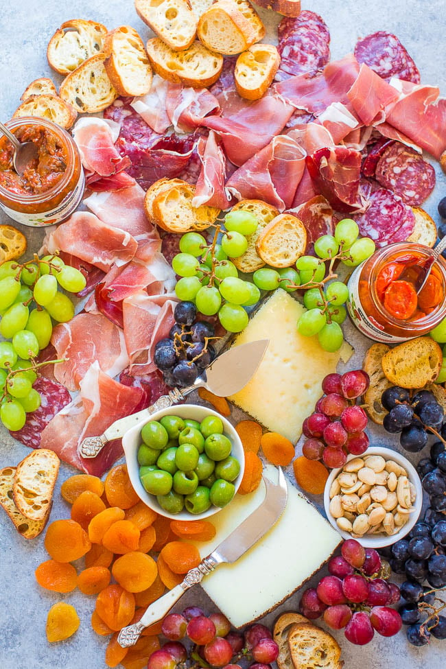 Easy Spanish-Inspired Cheese Board - Learn my TIPS and tricks to create the PERFECT cheese board!! From prosciutto to manchego and everything in between, this board has ALL the goodies! It'll be a major hit at your next party!! 