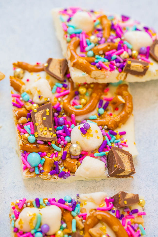 Loaded Unicorn Bark - Forget about that drink you missed out on and make this EASY white chocolate bark in 5 minutes!! It's LOADED with pretzels, peanut butter cups, marshmallows, and sprinkles! Guaranteed to put a SMILE on everyone's face!!