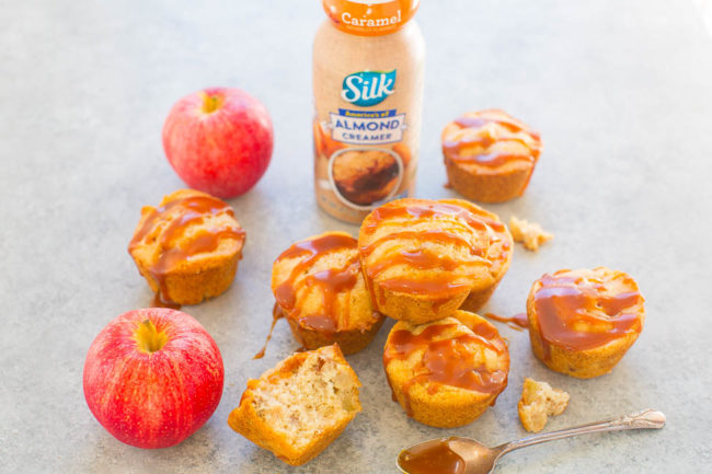 pile of apple muffins drizzled with caramel sauce with a bottle of Silk almond creamer in background 