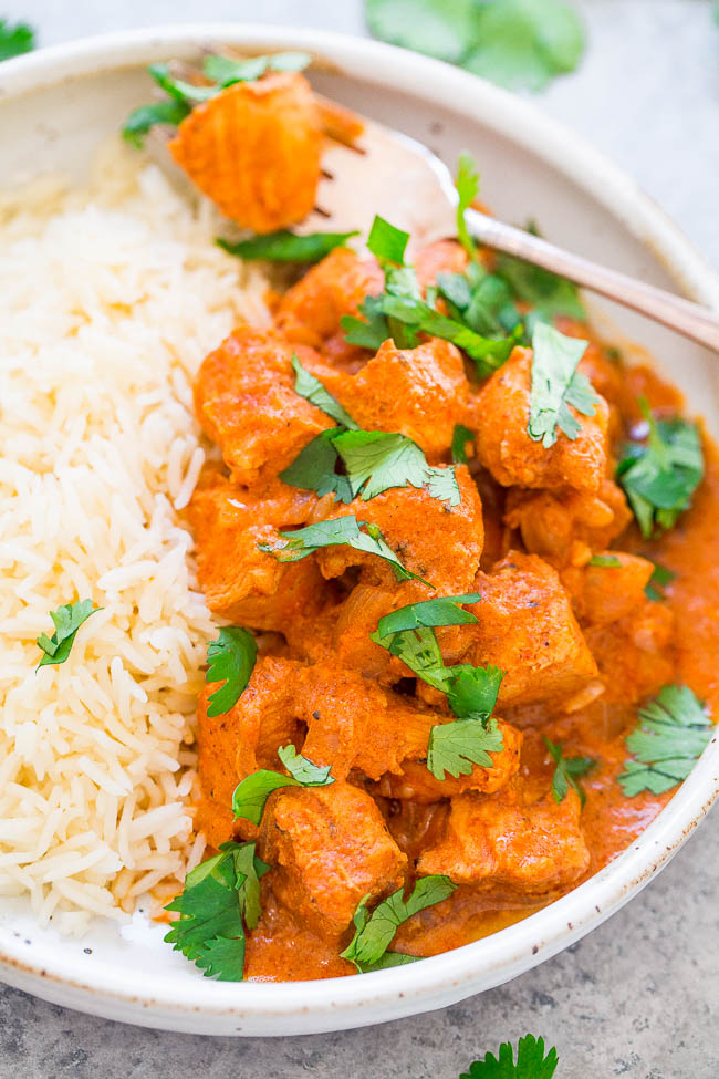 serving of instant pot tikka masala and basmati rice in a white dish with a fork 