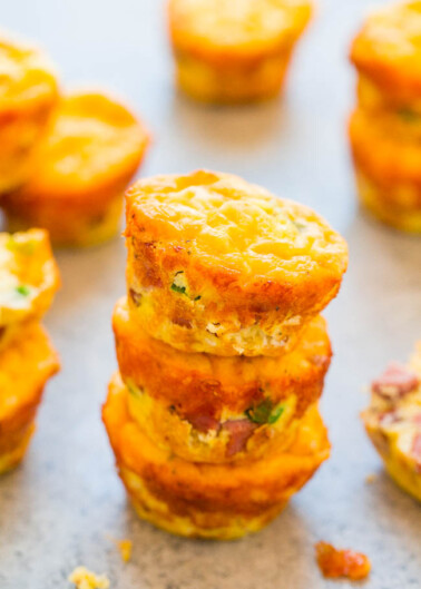 A stack of golden-brown mini egg muffins on a kitchen counter.