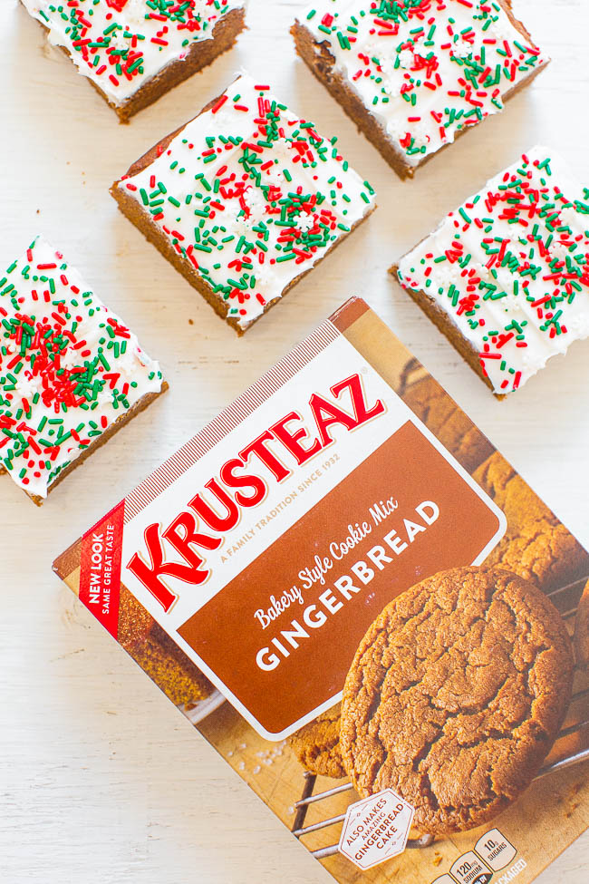 box of Krusteaz gingerbread cookie mix next to gingerbread bars topped with cream cheese frosting and holiday sprinkles