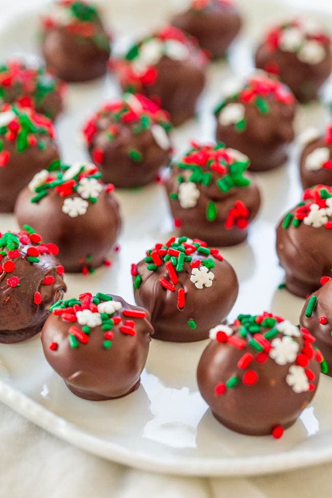A white tray of Chocolate Peanut Butter Balls decorated with holiday sprinles