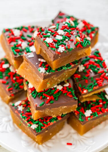 A stack of homemade holiday caramel squares topped with chocolate and festive red and green sprinkles.
