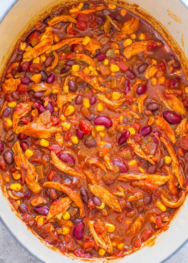 A pot of hearty chili with beans, corn, and shredded chicken.