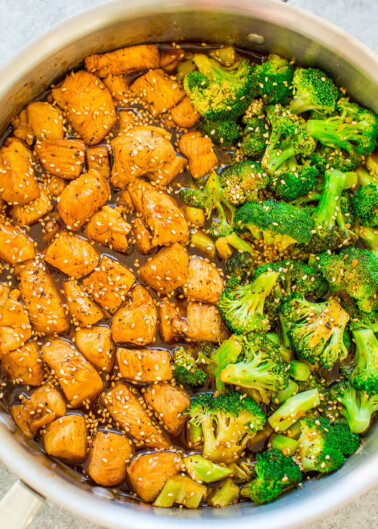 A pot of stir-fried diced chicken and broccoli in a sesame sauce.