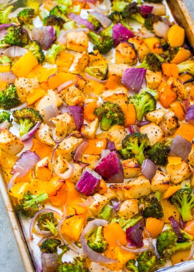 Roasted vegetables and chicken on a baking sheet.