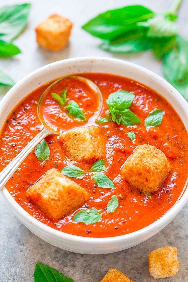 homemade Tomato Basil Soup in white bowl garnished with croutons