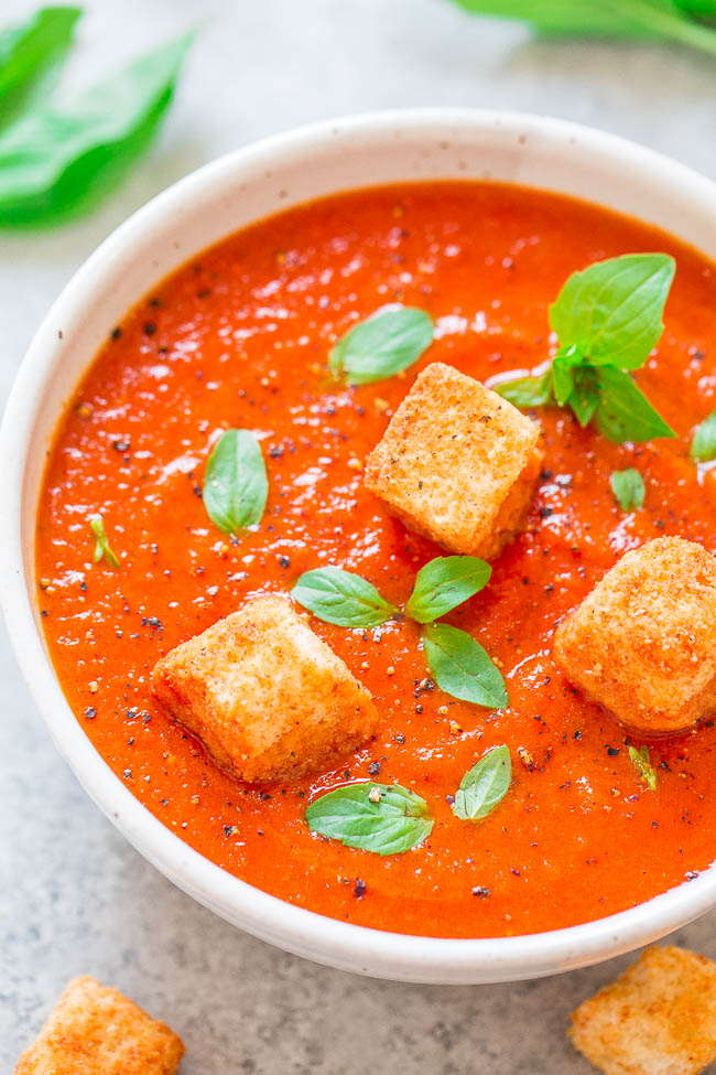 Tomato Basil Soup garnished with croutons and fresh basil leaves