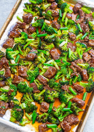 A baking sheet filled with roasted broccoli and chunks of beef covered in a glaze.