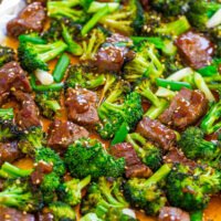 Stir-fried broccoli and beef with sauce on a baking sheet.