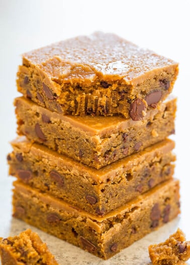 A stack of chocolate chip blondies on a white background.