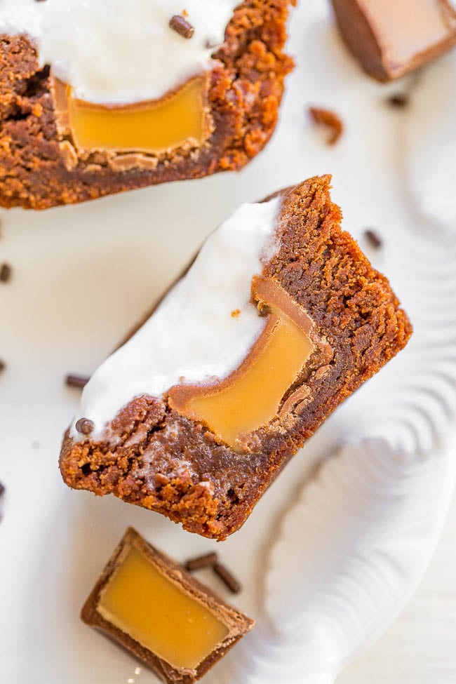 Close up of a brownie bite that's been cut in half to show the caramel filling. 