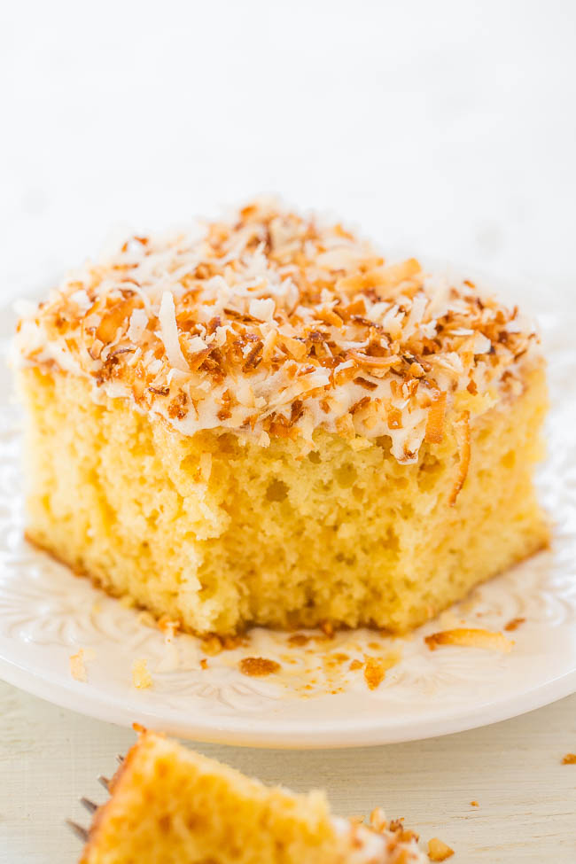Coconut Caramel Poke Cake - An incredibly EASY super moist cake thanks to a creamy caramel mixture that's poked into the cake!! Topped with crispy toasted coconut, this cake is a DELISH winner!!
