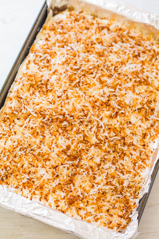 Coconut Caramel Poke Cake - An incredibly EASY super moist cake thanks to a creamy caramel mixture that's poked into the cake!! Topped with crispy toasted coconut, this cake is a DELISH winner!!