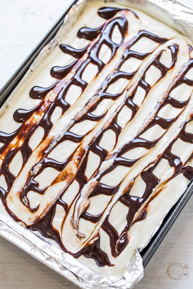 Fudge Ripple Brownies - Forget fudge ripple ice cream and try on of these EASY, decadent, and AMAZING brownies instead!! They're topped with a cream cheese-white chocolate pudding-whipped topping layer and chocolate sauce RIPPLES!!