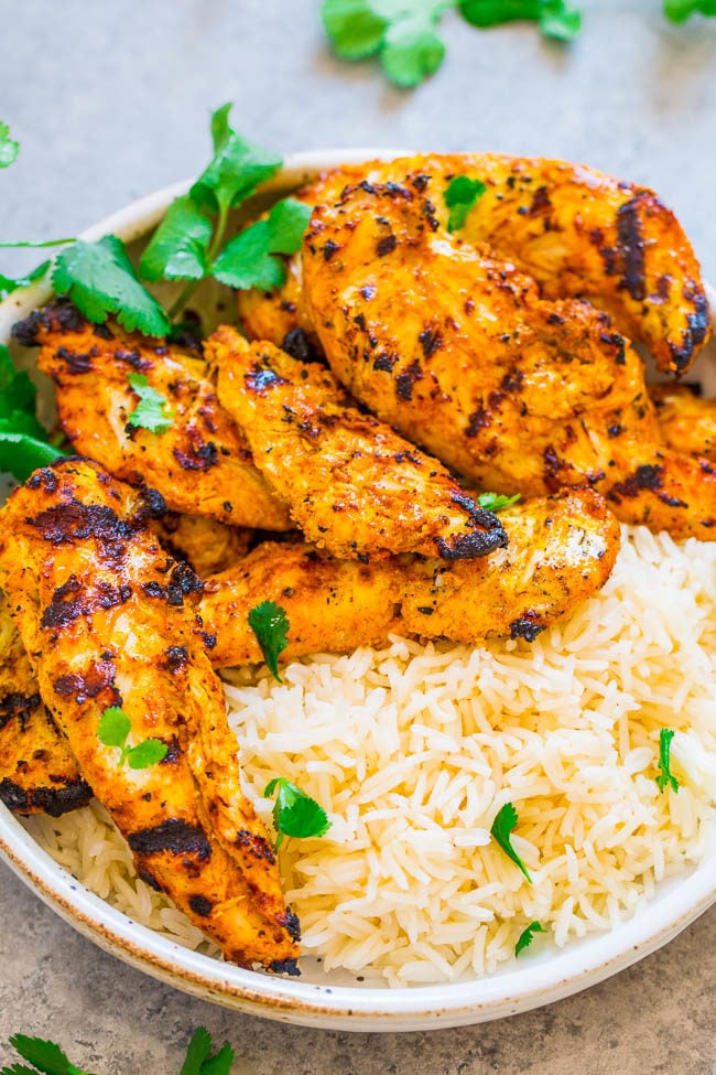 Grilled Tandoori Chicken with rice on a white plate 