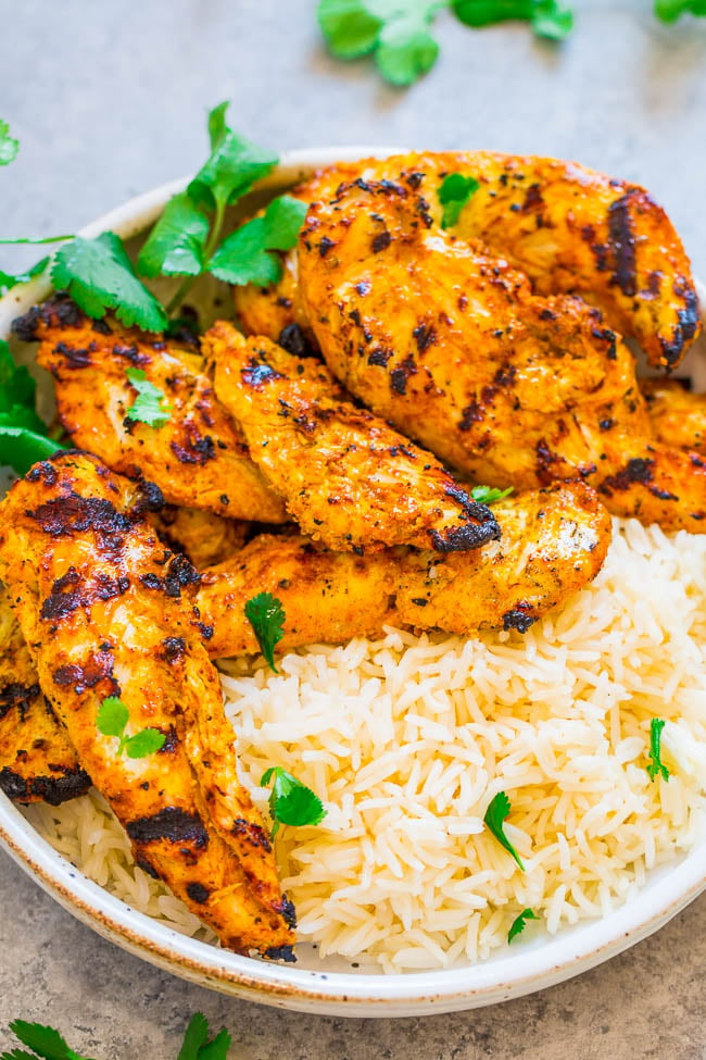 Grilled Tandoori Chicken and white rice in bowl with cilantro 