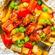 Grilled chicken and vegetable foil packet meal.