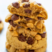 A stack of peanut butter chocolate chip cookies on a light surface.