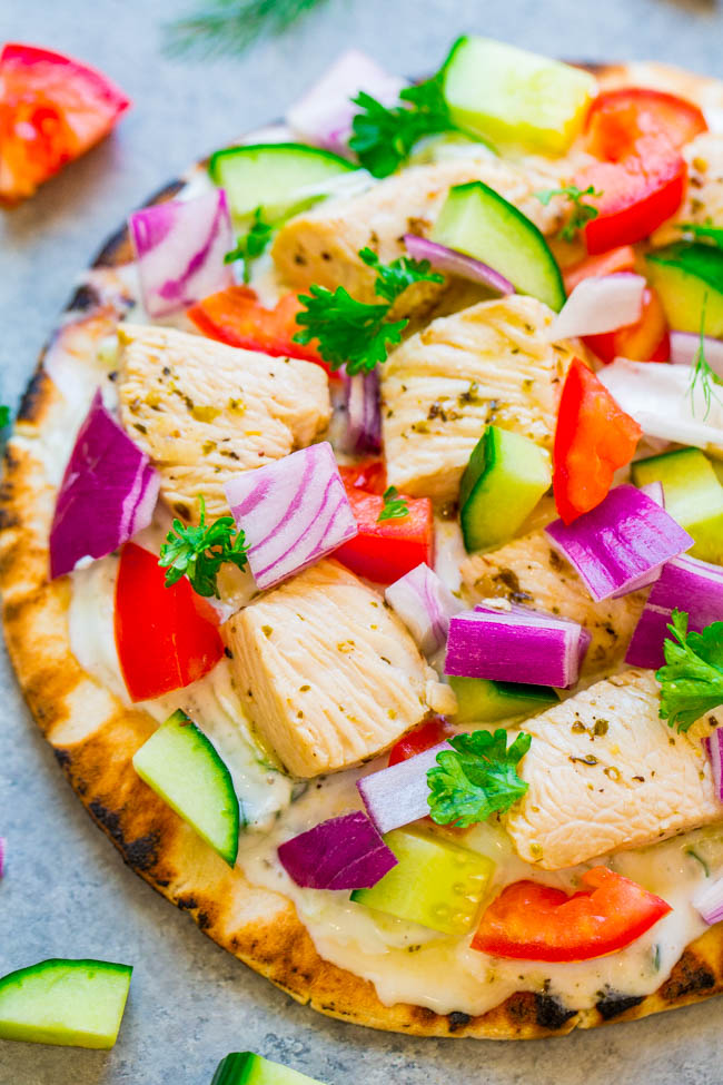 Greek Chicken Pita Bread Pizzas — Chicken gyros transformed into FAST, EASY, and HEALTHY pita pizzas!! There's juicy chicken, homemade tzatziki sauce, tomatoes, cucumbers, onions, and feta on pita bread!! FRESH and LIGHT!!