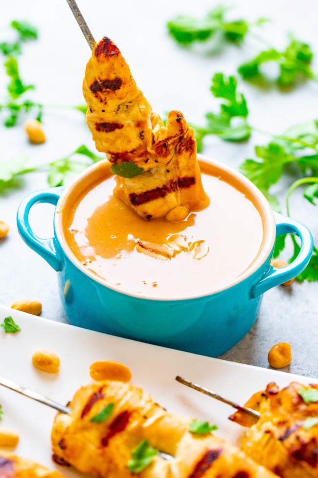 Easy Chicken Satay with Peanut Sauce dipped in a blue bowl
