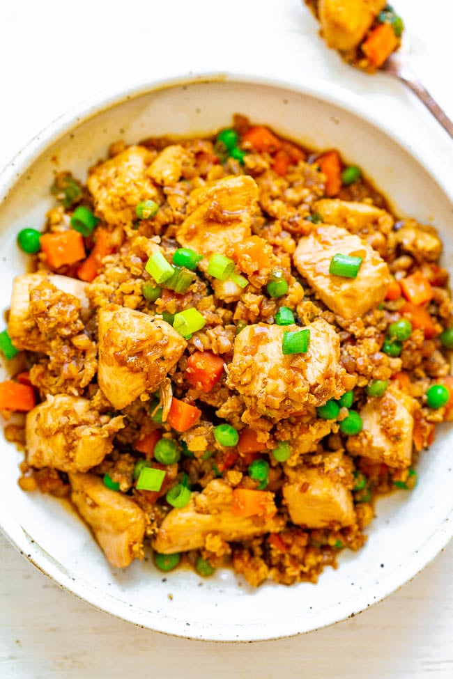 Skinny Chicken and Cauliflower Rice Stir-Fry — Even people who don't like cauliflower will be amazed at how authentic and DELICIOUS this SKINNY version of chicken fried rice tastes!! Easy, ready in 15 minutes, and so much HEALTHIER than calling for takeout!!