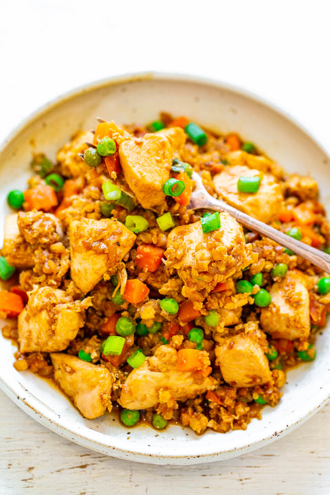 Skinny Chicken and Cauliflower Rice Stir-Fry — Even people who don't like cauliflower will be amazed at how authentic and DELICIOUS this SKINNY version of chicken fried rice tastes!! Easy, ready in 15 minutes, and so much HEALTHIER than calling for takeout!!