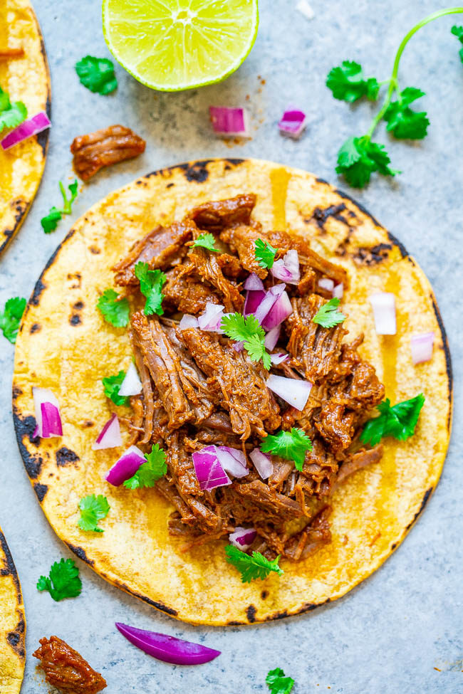 Overhead shot of Instant Pot or Slow Cooker Barbacoa Beef on a tortilla
