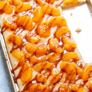 A baking sheet of caramel apple sheet pan pancakes with pieces missing.