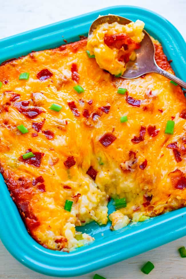 Loaded Twice Baked Potato Casserole - Tender potatoes mixed with butter, cheese, sour cream, bacon, and green onions for the ultimate in LOADED baked potatoes!! AMAZING comfort food that's irresistible!!