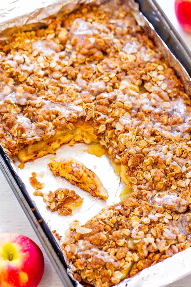 baking tray of cinnamon roll apple bake with a slice missing 