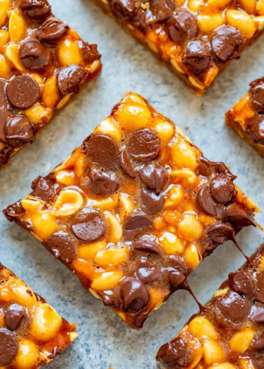 Chocolate chip and caramel nut bars on a baking sheet.