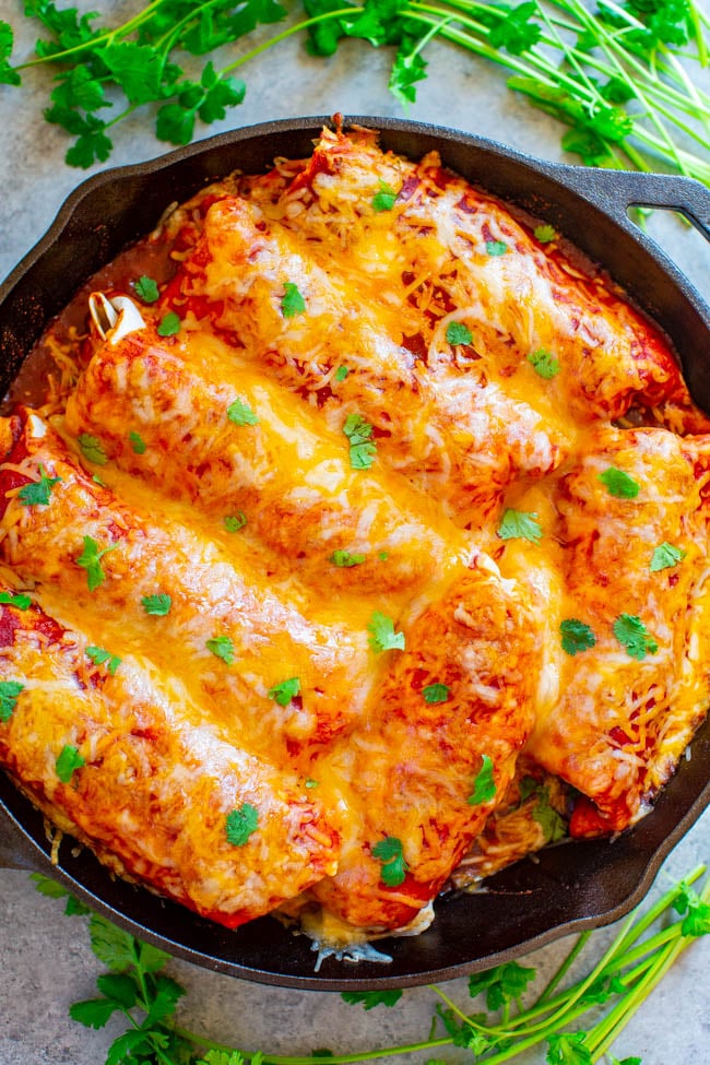 Loaded Smothered Beef Burritos — Mexican comfort food that's loaded with seasoned ground beef, refried beans, rice, and smothered with sauce and CHEESE!! Tastes BETTER than from a restaurant, plus these burritos are freezer-friendly and so EASY!!